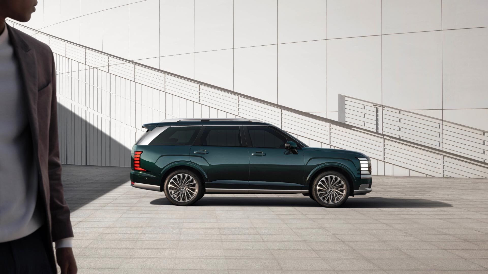 Side-front view of orange Grandi10 with lakeside view at night